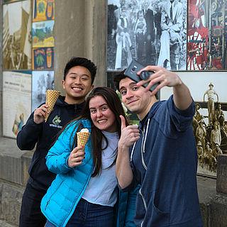 Three students take a selfie while holding ice cream cones in downtown Walla Walla